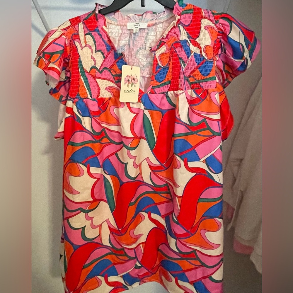 ENTRO smocked vibrant top with flutter sleeves.